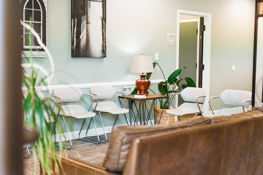 The Babb Center waiting area with chairs, a lamp, and plants